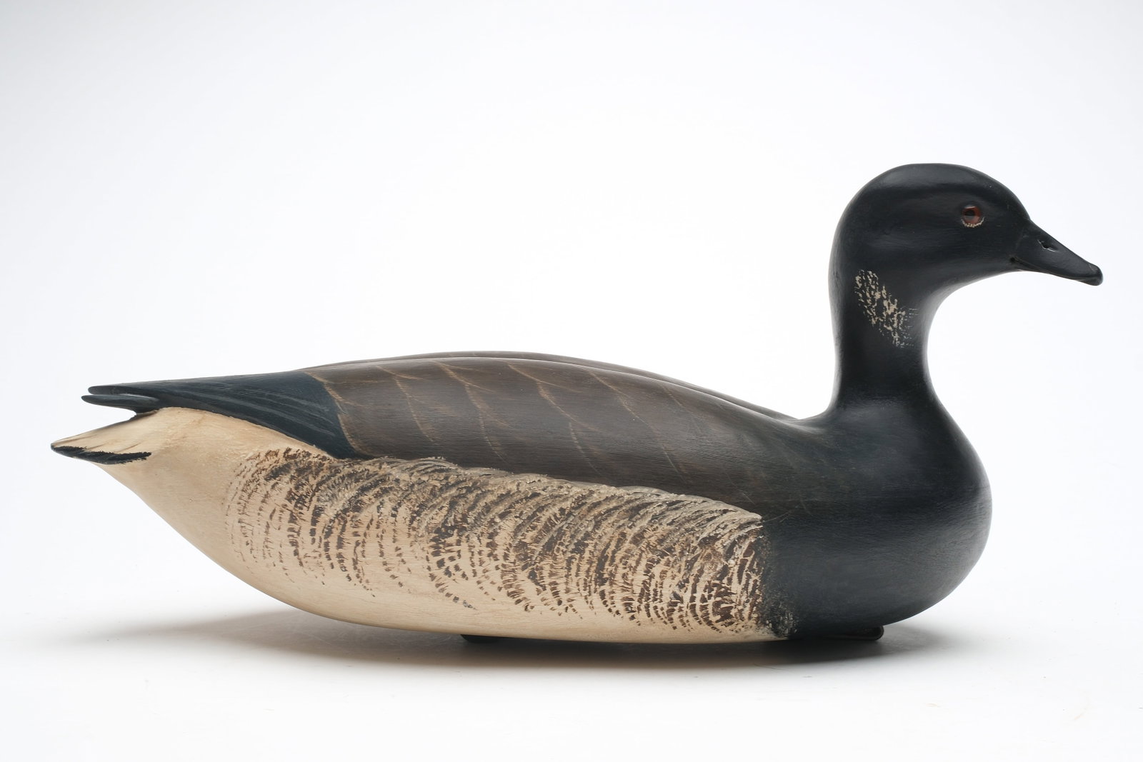 Robert "Bob" White (b. 1939) Tullytown, Pennsylvania.: Brant with raised crossed wing tips and slightly turned head. Maker's typical lead weight on underside. Measures 17" long.