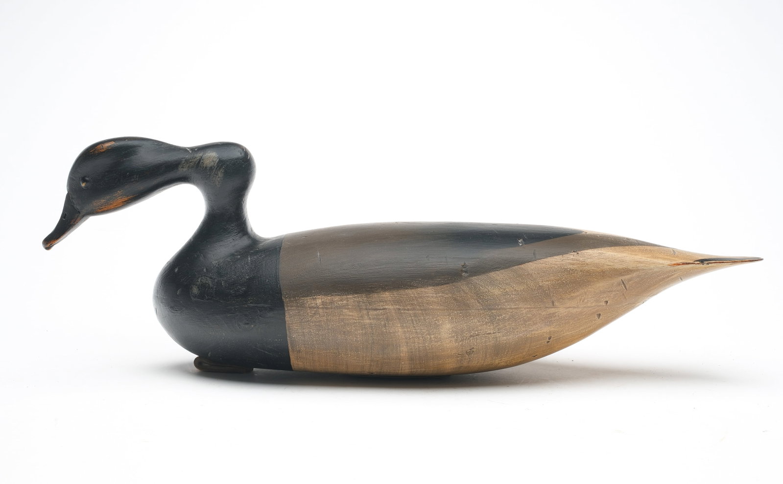 Robert "Bob" White (b. 1939) Tullytown, Pennsylvania.: Hollow carved snakey neck Brant with tack eyes. Maker's oval brand on bottom. Measures 17.5" long.