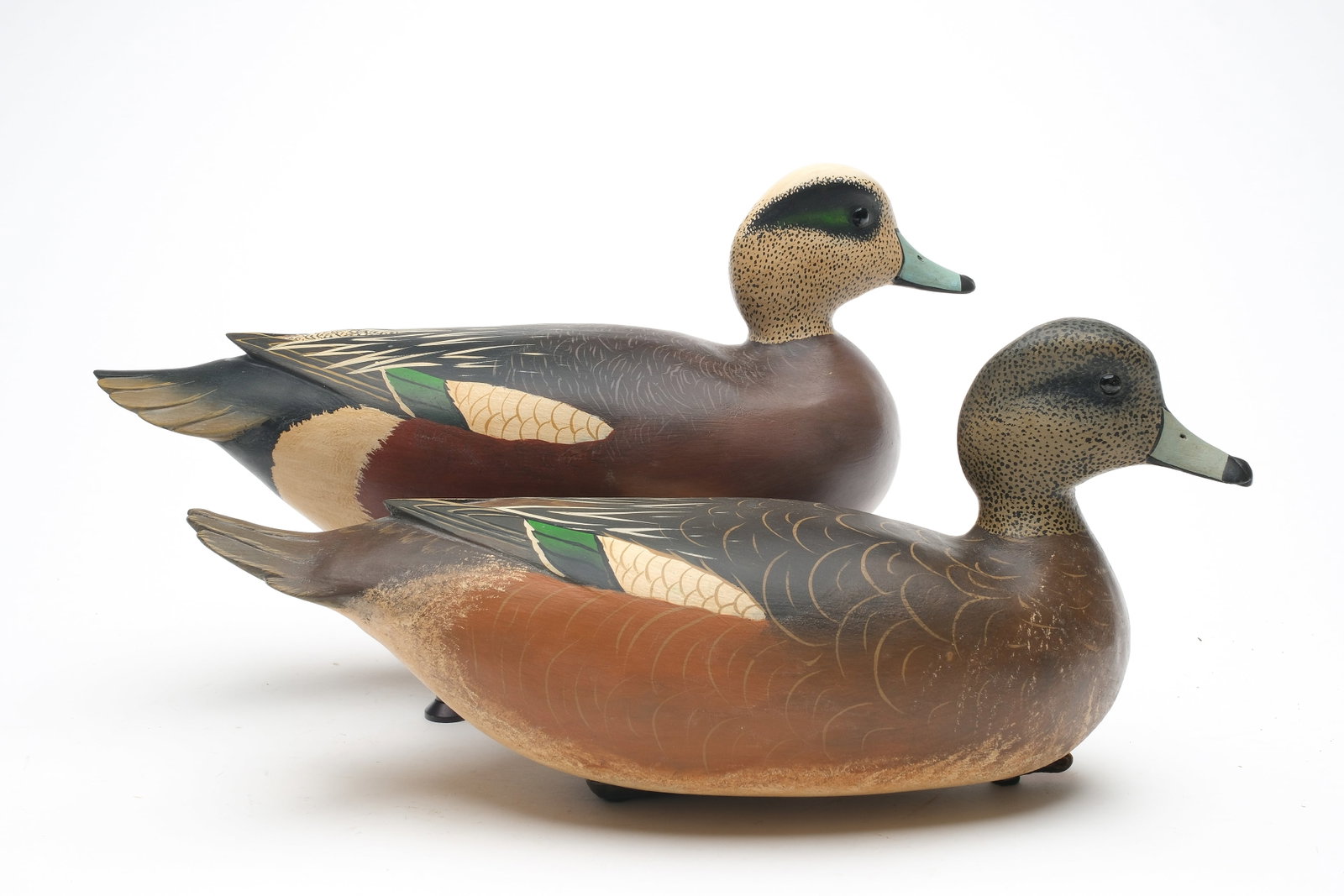 Robert "Bob" White (b. 1939) Tullytown, Pennsylvania.: Pair of hollow carved wigeon with raised wing tips and glass eyes. Signed and dated 1995. Maker's typical weight on underside. Drake measures 14" long.
