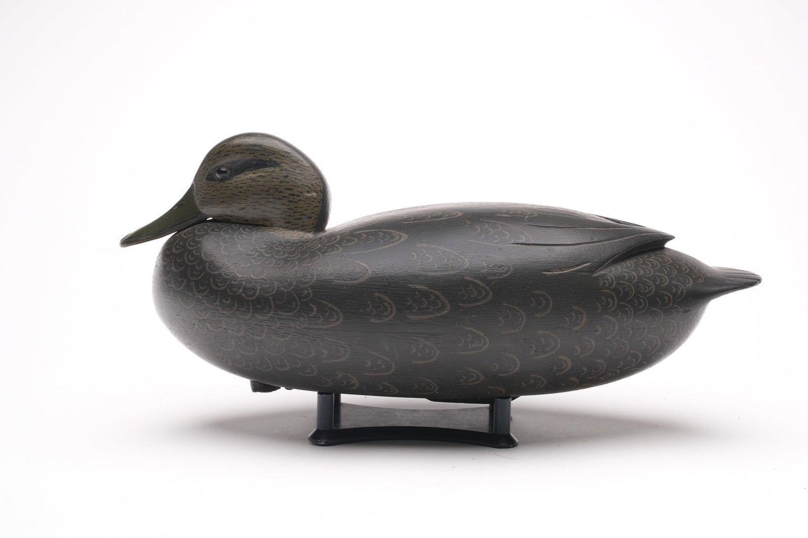 Joe King (1905-1992), Edgely, Pennsylvania.: Tucked head black duck. Hollow carved with raised V wingtip carving. From the maker's personal rg with name and town stamped in lead weight. Measures 15.25" long.