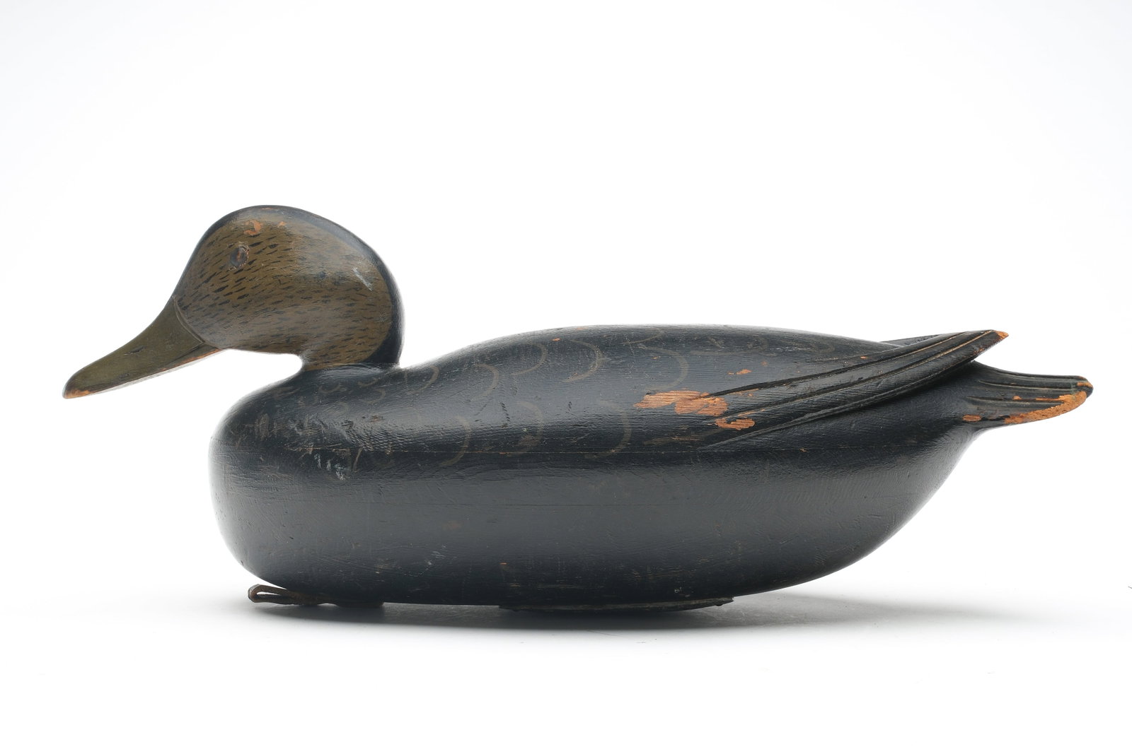 Jess Heisler (1891-1943), Burlington, New Jersey.: Black duck. Three piece hollow carved body with raised V wingtips and relief tail feather carving. Measures 16.25" long. Provenance: John Decesare collection.