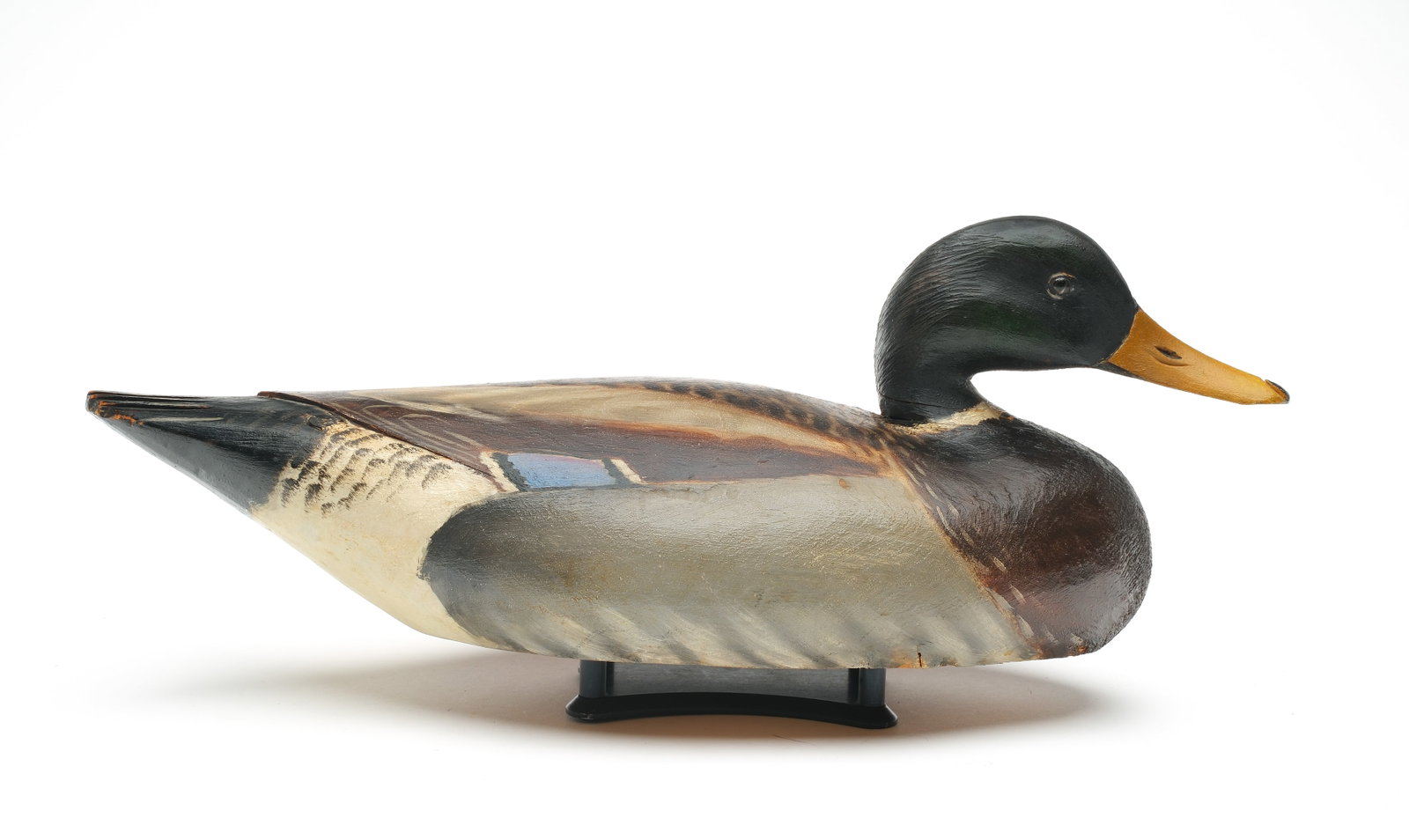 A. Elmer Crowell (1862-1952), East Harwich, Massachusetts.: Mallard. Maker's rectangle stamp on underside. Slighty turned head and relief tail and wingtip carving. Measures 17.25" long.