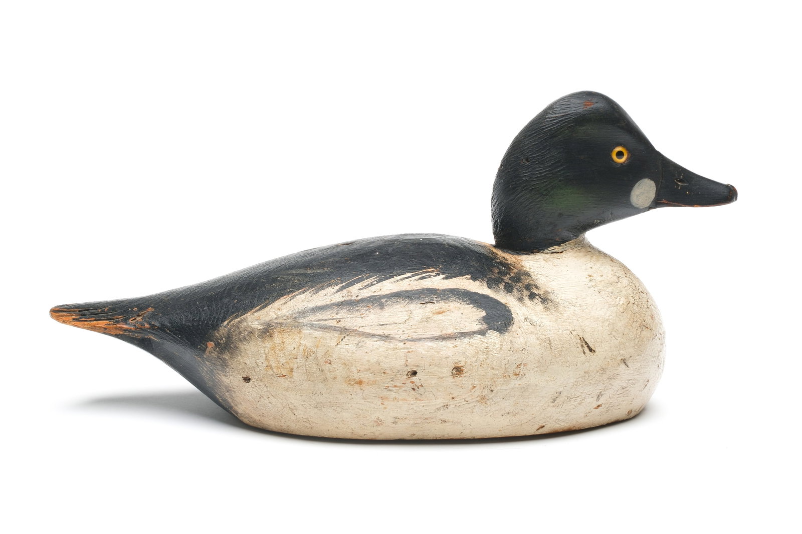A. Elmer Crowell (1862-1952), East Harwich, Massachusetts.: Goldeneye. Maker's oval brand on underside. Relief tail feather carving. Measures 15" long. Provenance: John Decesare collection.