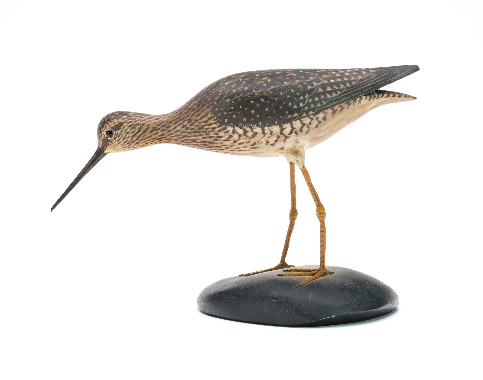 A. Elmer Crowell (1862-1952), East Harwich, Massachusetts.: Decorative walking yellowlegs. Raised wingtips and relief tail feather carving. Maker's signature and rectangle stamp on underside of base. Measures 13.25" long. Provenance: Martin and Deborah Maloy c