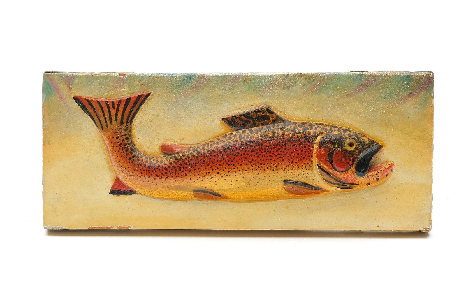 Oscar Peterson (1887-1951), Cadillac, Michigan.: Relief carved rainbow trout with desirable flip tail. Glass eye, metal strapping on back and sides. Written in pencil "Made by Oscar Peterson 223 Cadillac, Michigan, Rainbow trout." Plaque m