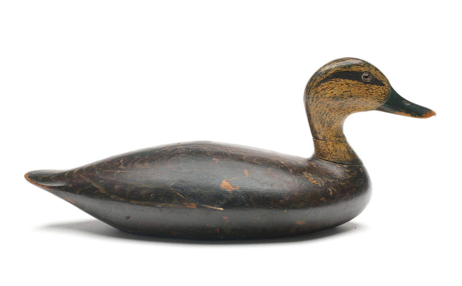 Nicely carved black duck from Ontario.: Two piece body with excellent head carving. Made by the same maker as the famous stickup wood ducks from Ontario. Measures 15.5" long.