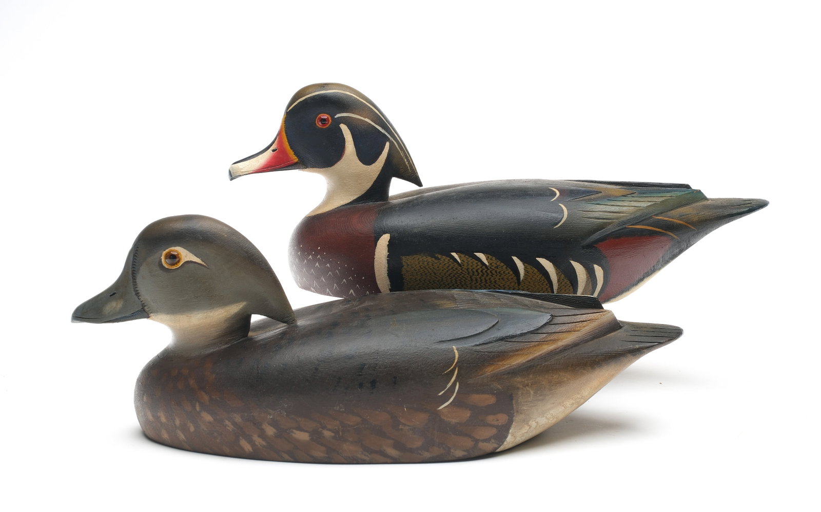 David W. Nichol (1890-1977), Smith Falls, Ontario.: Pair of wood ducks. Relief wing and tail feather carving. Both with extended crests. Measures 13.5" long Provenance: Dean Hyde collection.