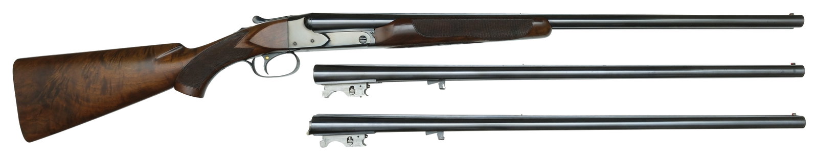 EXCEPTIONALLY RARE AND FINE WINCHESTER MODEL 21 TOURNAMENT GRADE ORIGINAL THREE BARREL SET: WITH FACTORY BOXES. SN. 10169. Cal. 20ga. Built in 1935 as a factory original 3 brl set. All 3 sets measuring 26" long with 2-3/4" chambers and matted concave top ribs that have steel mid and Br