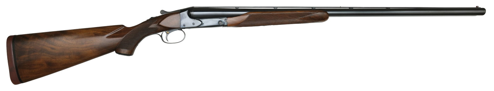 VERY RARE SPECIAL ORDER WINCHESTER MODEL 21 12 BORE DELUXE TRAP.: SN. 25698. Cal. 12ga. Built with 30" ventilated rib brls that have white mid and red front beads. Walnut beavertail forend is point pattern checkered with blued roller type release and iron. Blued rec