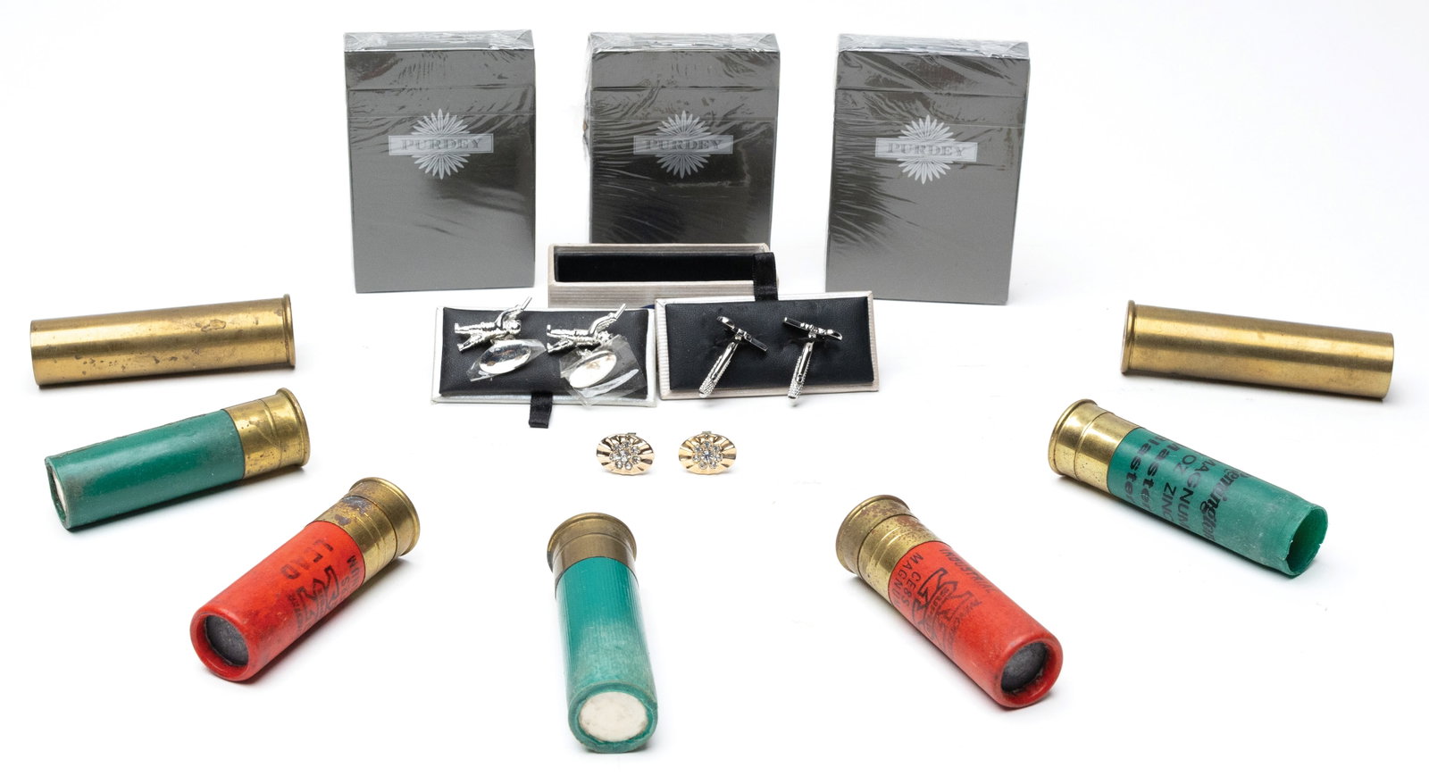 8 GAUGE SHOOTERS AND VINTAGERS LIFESTYLE AMMO LOT.: This lot consists of seven 8ga shells including two unprimed brass, one spent Remington shell, and four primed and loaded Winchester and Remington shells. Lot also includs three unopened Purdey