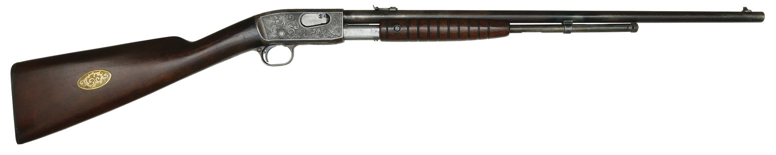 INTERESTING REMINGTON MODEL 12 WITH EARLY PERIOD ENGRAVING.: SN. 262921. Cal. .22S,L,LR. Built with 22" blued round brl that has usual maker's stamps and adjustable rear sight and fixed blade front sight. Grooved walnut forend. Receiver is nicely punch dot shad