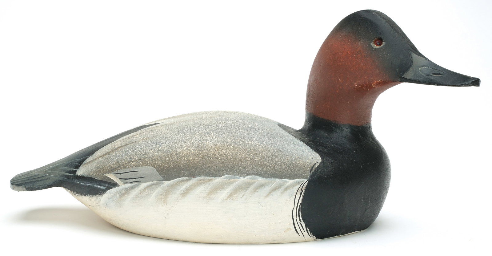 Ward Brothers, Crisfield, Maryland.: Canvasback. Hollow carved shooting stool model. With slightly turned head and thick stipple paint on back. Signed and dated 1967 on underside. Measures 17.5" long.