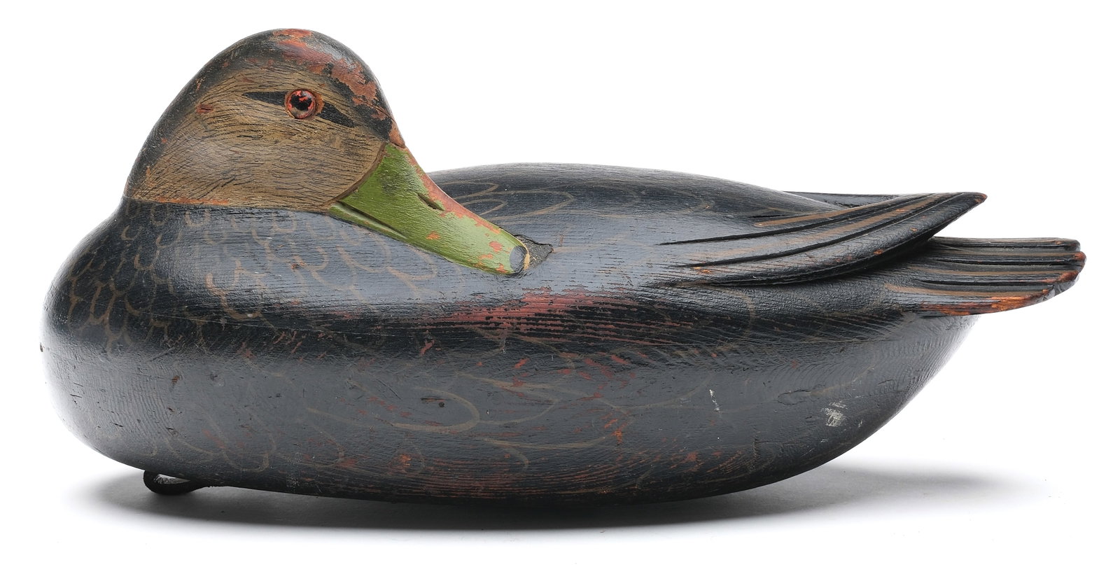 Jess Heisler (1891-1943), Burlington, New Jersey.: Rare sleeping black duck. Three piece hollow carved body with raised V wingtips and deep relief tail feather carving. Painted tack eyes. Measures 14.5" long. PROVENANCE: Don Leonard collection.