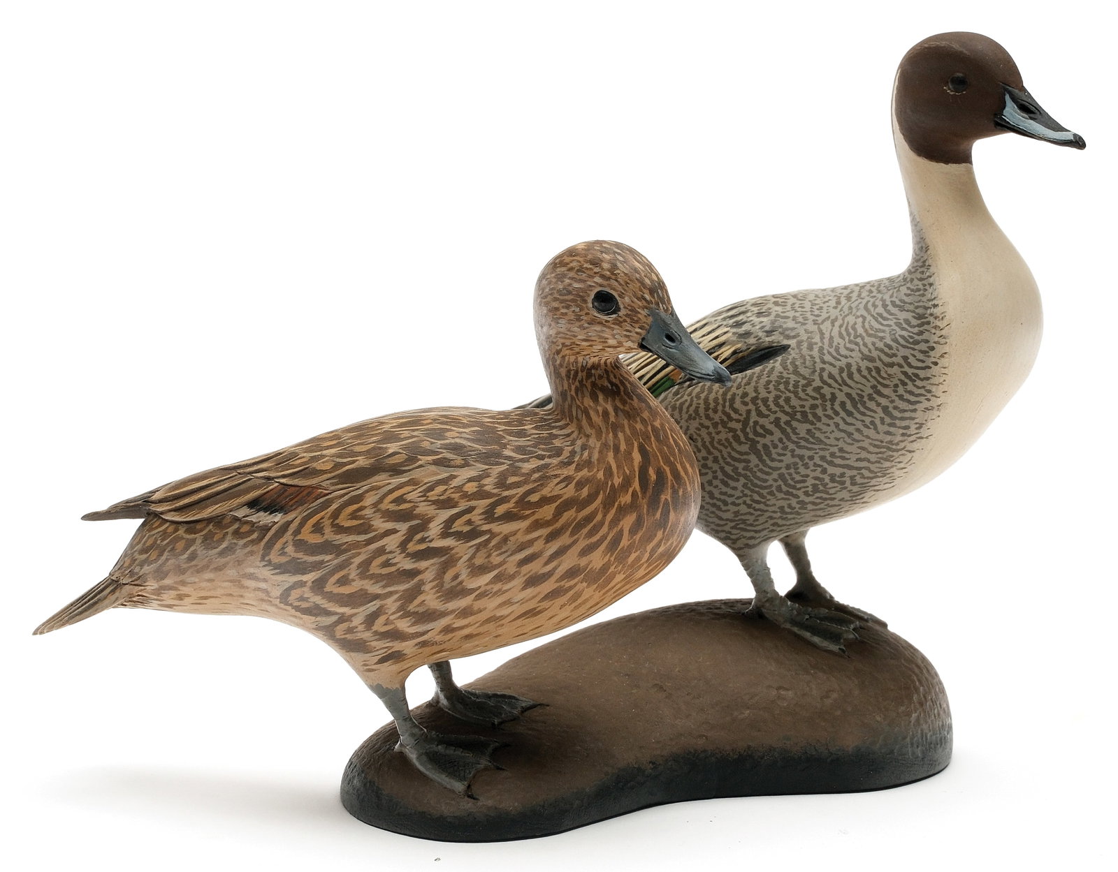 Eddie Wozny (b.1959), Cambridge, Maryland.: Pair of miniature pintails. Slightly turned heads and raised crossed wingtips. Relief feather carving. Signed and dated 2005 on underside. Birds measure 4.5" and 5.5" long. 