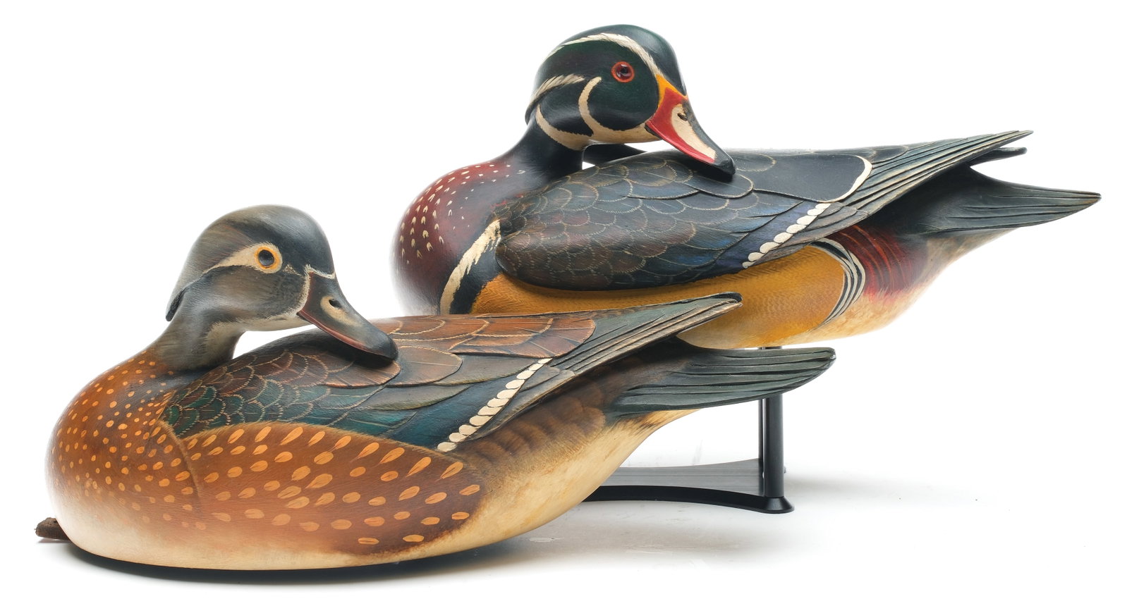 William Gibian (b.1946), Onancock, Virginia.: Excellent pair of wood ducks. Hollow carved with deep relief wing and tail feather carving. "Gibian" carved in undersides. Maker's business card is signed and dated 4/13. Measure 14.5" long.