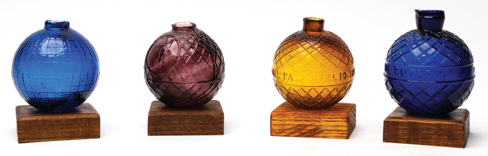 GROUP OF FOUR GLASS TARGET BALLS WITH STANDS (1 of 2)