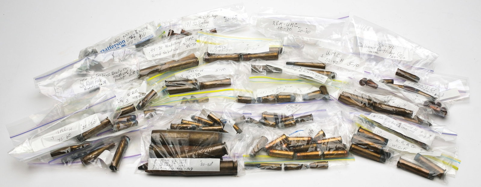 ANTIQUE AND COLLECTIBLE RIFLE AMMO LOT.: This lot consists of a number of older mostly black powder rifle cartridges some of which are primed some of which are spent brass. Calibers include .44 Henry spent case, .45-70, .32-40, .58 Short
