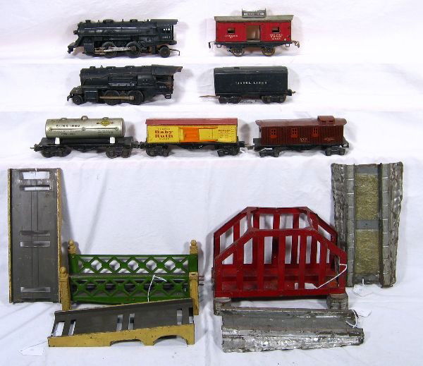 NETTE - 9 Pc. Pre War Lot: Ives 3-Pc Bridge, approaches are C-1(no paint); 67 Caboose, missing copula roof; Lionel - 106 3-Pc Bridge, missing 1 finial, o/w C-6(Very Good); 1654 Loco; 258 Loco; 1689T Tender, missing 2 wheels; 16