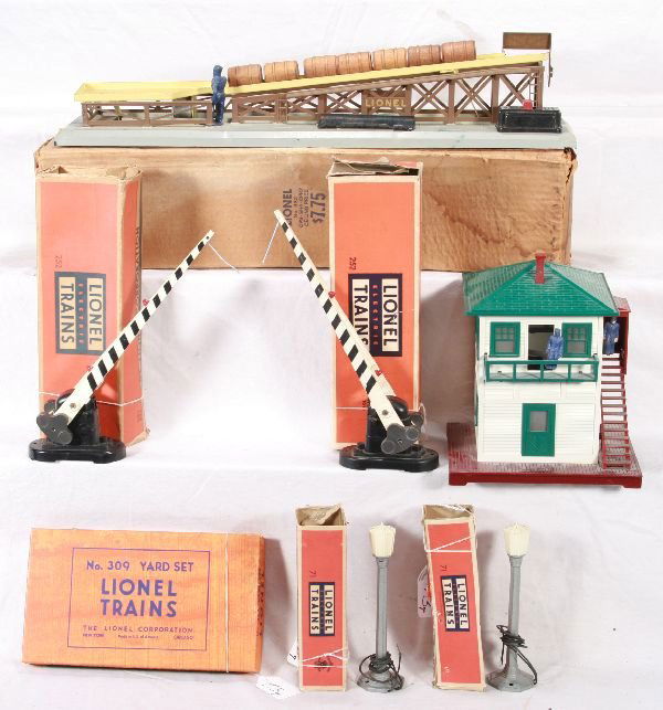 NETTE - 7 Boxed LIONEL Accessories: 2 #71 Lamppost; 2 #252 Crossing Gate; 445 Switch Tower; 309 Yard Set; 362 Barrel Loader, complete, some obs rough, should clean to C6+
