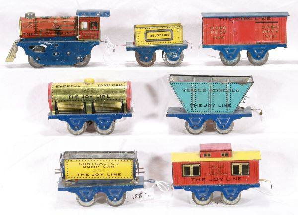 NETTE - 7Pc. MARX/ Joy Line Set: 350 Steam Loco, clock work working; 351 Koal Kar Tender; 352 Venice Gondola; 353 Everful Tank Car; 354 Contractor Dump Car; 355 Hobo Rest Boxcar, 'R' etched on door; 356 Eagle Eye Caboose, nice matche