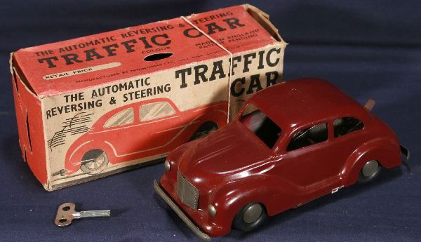 NETTE - Boxed MINIMODELS Traffic Car: Made in England, litho tin, 6" L, Morris Oxford would be our guess, clock work working w/key, wheels turned when held, no action when placed on table? Minor wear to ob, C7+