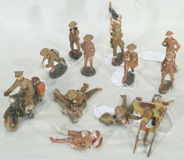 NETTE - 12 Pc. ELASTOLIN Soldiers Lot:: Dispatch rider w/tin wheels, some rust; Prone behind log w/field glasses, 1 loose arm; Tin Machine Gun, w/feeder figure; Running w/grenade; Standing w/phone; Standing, hand on hip; Officer w/field gla