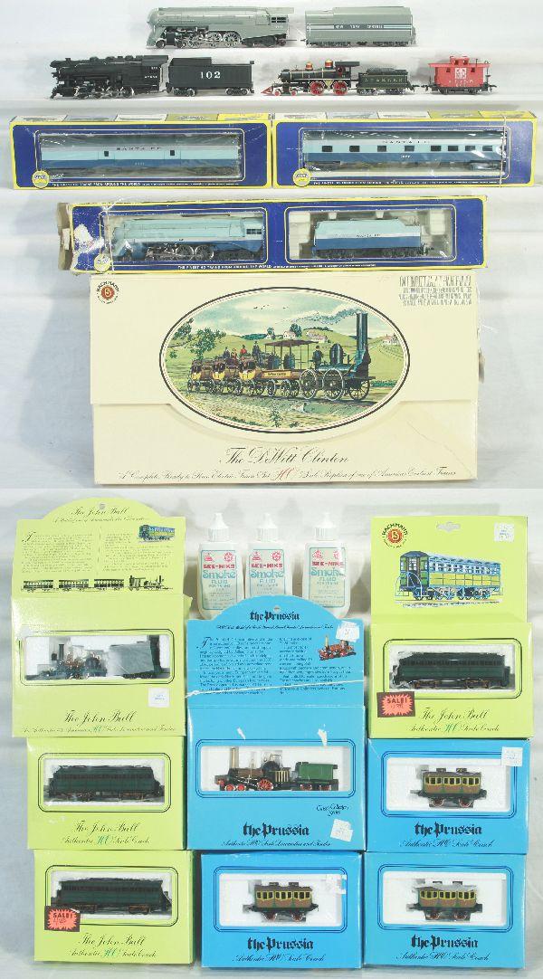 NETTE - 18 Pc. HO Ga. Lot:: 4 Pc. Bachmann John Bull Set, obs; 4 Pc. Bachmann Prussian Set, obs; Dewitt Clinton Set, osb all appear as new, C9; AHM SF Blue Goose Hudson, some touch-up on tender, ob worn, C5; 2 matching Pass Cars