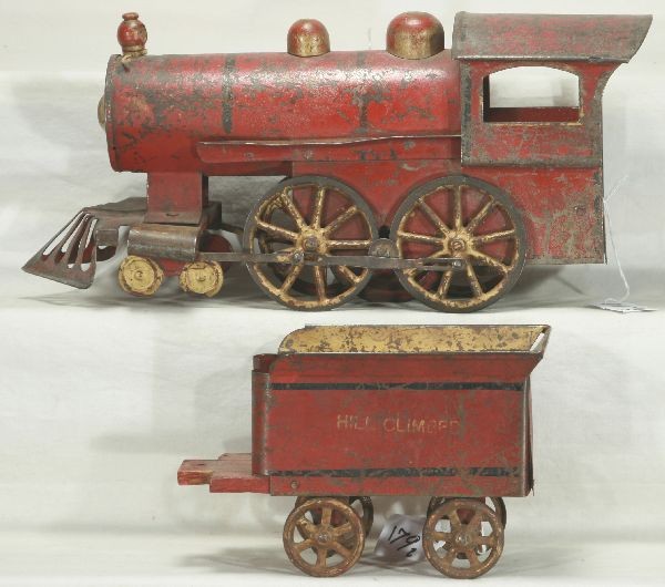 NETTE - Early HILL CLIMBER Loco Toy:: Circa 1899, painted Pressed Steel, tin & wood, Friction fly wheel working, lettering readable, 22" over-all L, missing stack, C3-4