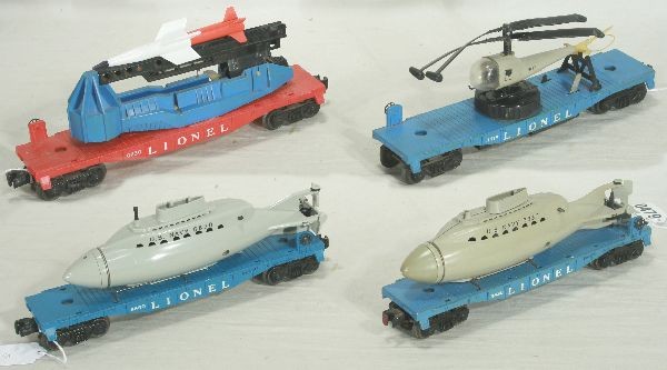 NETTE - 4 LIONEL Space Cars:: 3419 Flat w/Helicopter, tough light blue flat, large winder w/twin blade copter; 3830 Flat w/Oper. Sub, missing periscope, cracked; 6650 ICBM Launcher; 6830 Flat w/Non operating repro Sub, o/w C7