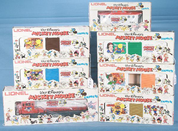 NETTE - 7 Pc. LIONEL MPC Disney Set:: 8773 U36B Diesel; 8665 Peter Pan; 8666 Pinocchio; 8667 Snow White; 8668 Pluto; 8672 Mickey Mouse; 9183 Caboose, clean white obs, C9