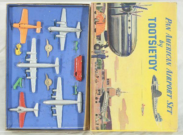 NETTE - Boxed TOOTSIETOY 6500 Pan Am Airport Set: Tough set to find! 2-prop plane missing front wheel set, all props intact w/scarce Luggage train & stairs, 2 original pin backs, obs w/inserts C7+-8