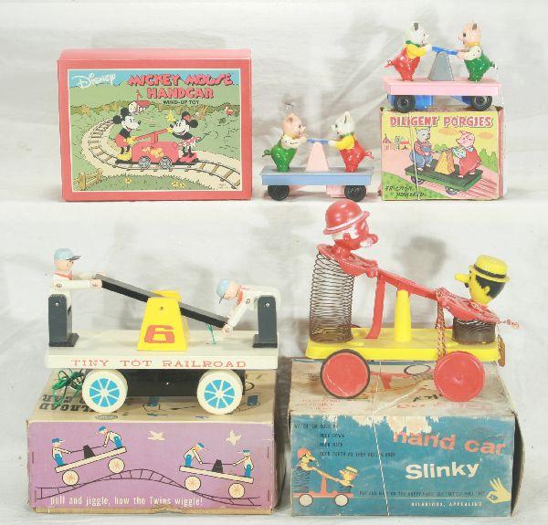 NETTE - 5 Boxed Handcar Toys:: 400 Slinky Handcar, oxi on metal, plastic car, 8"W, ob worn, o/w C7; Sears Wooden Tiny Toy Railroad, 8"W, ob C9; 2 MP Japan, HP Pig friction Handcars, 1 ob, C8; Schylling Modern Mickey Mouse Handcar, 
