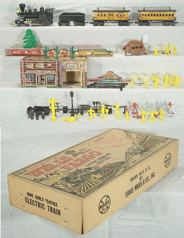 NETTE - Scarce Boxed MARX Tales of The Wells Fargo: Set #54762. This deluxe set is in great shape! Wm Crooks Loco, missing 1 handrail, stanchions intact; TFG Tender, lettering readable both sides, but light; Bag of Indians; Bag of Cowboys; Bag Stage Co