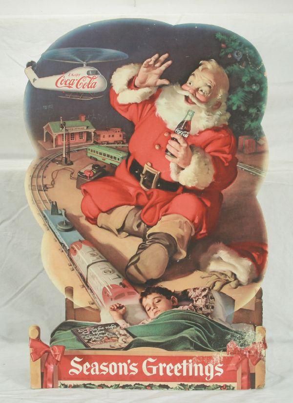 NETTE - 1960s COCA-COAL Display with Lionel Trains: Another classic advertisement, paper on board, 24" Tall w/easel back, shows Lionel style trains w/helicopter car launching a Coca-Cola Copter w/Santa, bright w/minor surface wear, C6+