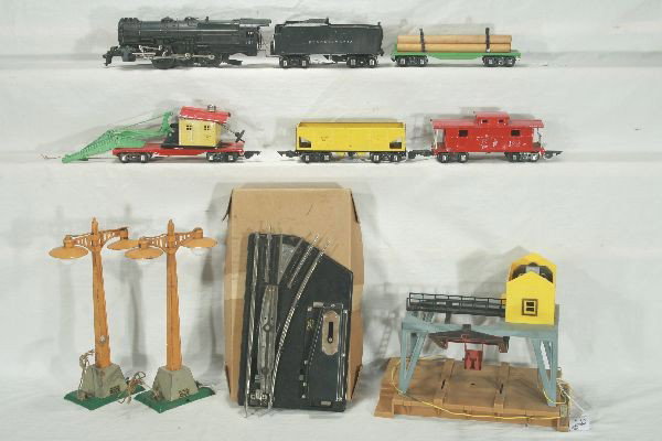 NETTE - 10 Pc. AMERICAN FLYER O Ga. Lot:: 561 Pacific Loco, incomplete, 558 Tender w/Choo Choo, cab has major warp; 481 Red Frame crane, needs boom; 486 Hopper; 482 Log Car; 484 Caboose w/light; 2 Double lampposts, 1 missing insert; Log Loade