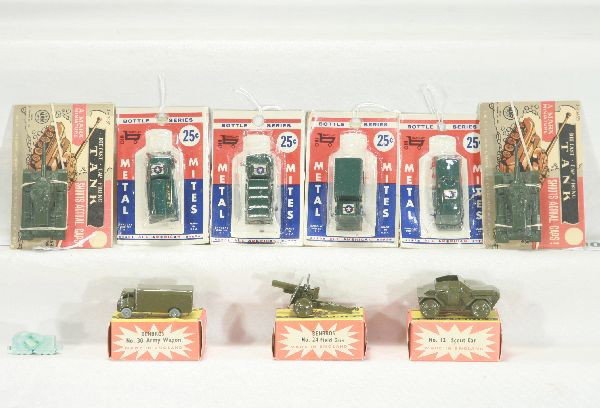 NETTE - 10 Pc. Military Diecast Vehicle Lot:: 5 Barclay Bottle series trucks, sealed on cards, C10; 2 Marx Cap shooting tanks, on cards, C9+; Benbros, Army wagon, Howitzer & Scout car w/obs C9+