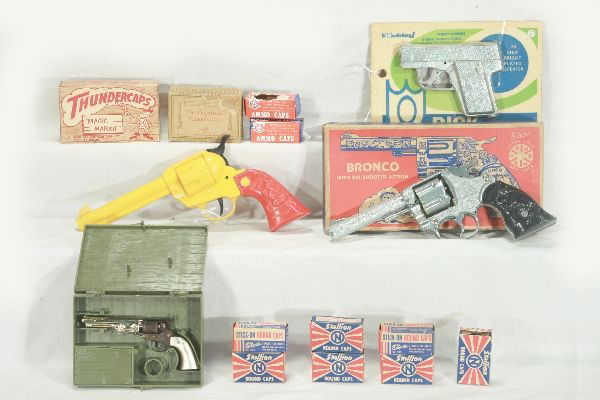 NETTE - 9 Pc. GUN & CAP GUN Lot: Kilgore Bronco, diecast, working, ob C9; 2 boxes Kilgore caps; 4 Boxes Nichols Stallion Caps, obs; 2 AOK roll caps in worn boxes; 4210 Hubley Dick, sealed on card, C10; Magic Marx Thunder Caps, ob; Ma
