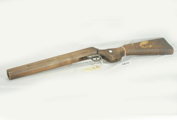 NETTE - MARX PROTOTYPE Cap Shot Gun: Circa 1940, Carved wood w/CI mechanism, 26" L, western style decal on stock only 30% remains, cannot read, Barrel folds down for loading, 6" crack in stock at hinge, interesting design.