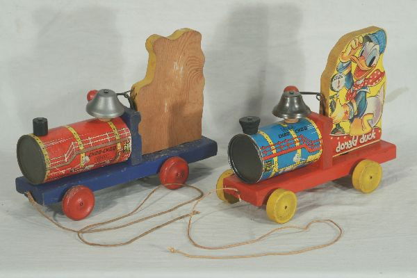 NETTE - 2 Early FISHER PRICE Donald Duck Toy Train: Both black labeled pre war. 450 Choo Choo w/blue boiler, bright & clean w/string, C7+; Larger 450 Choo-Choo, missing Donald litho one side, other a bit worn, C5 ish