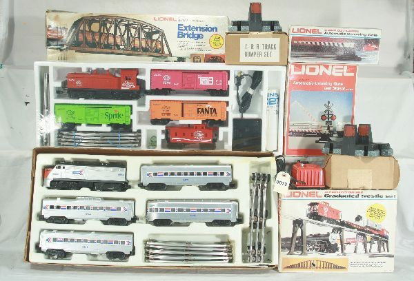9 pc Lionel Lot: 6-1463 Electric train Coca Cola set, mint sealed, box cover has water damage; 6-1663 Amtrak Lake Shore limited Electric train set; 6-2122 Extension Bridge; 6-2110 Graduated trestle set; 6-2162 Automat