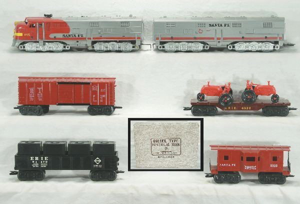 Boxed Marx diesel set 44884: 1095 Santa Fe E7 AB diesels, silver plastic mold, Erie gondola w/ canisters, orig. insert, 4528 Erie flat w/ red tractors, RI box car, 2225 Santa Fe bay window caboose w/ orig .stack and antenna, trac