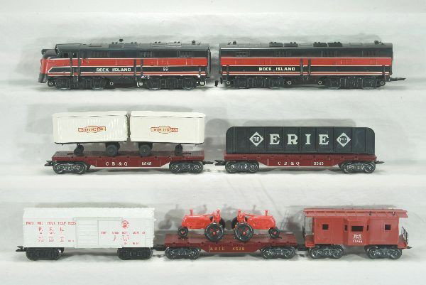 Boxed Marx diesel set 44824: 99 RI E7 AB diesel, missing horns, Erie flat w/ red tractors, PFE box car, 5545 flat w/ Burlington trailers, CB&Q flat w/ girders, no hold down, RI bay window caboose broken antenna missing stack, osb