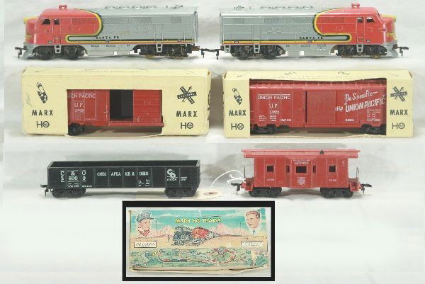 Boxed Marx HO set 63452: Santa Fe F 3 AA diesels, 2 boxed UP box cars, C&O gondola missing 1 coupler, Santa Fe bay window caboose w/ broken stack, osb worn but powerful, Has light to moderate play wear.