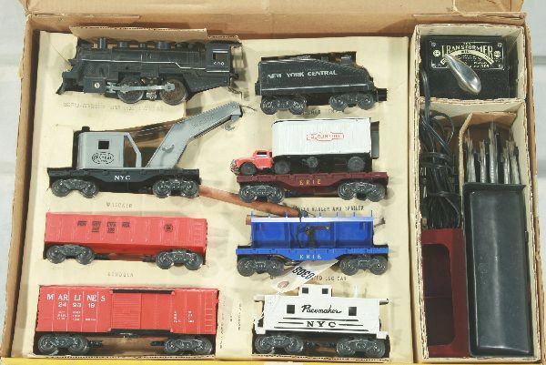 Unusual boxed Marx set 25215: Top open set box w/ display insert, 490 loco w/ chug chug sound, NYC wedge tender, NYC crane complete, Erie flat w/ Burlington tractor trailer, gondola, blue Erie log dump car, Marline operating box c