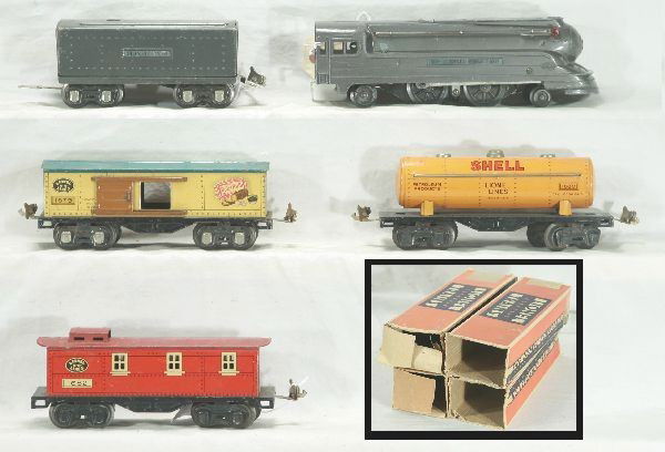 5 pc Lionel Jr Steam Freight Set: 1688E Pennsylvania torpedo Loco- missing one running light; 1689W Tender, gunmetal, OB; 1679 Baby Ruth boxcar- OB; 1680 Shell Tank car, OB; 1682 Caboose, OB, OB's are rough, Has moderate play wear.