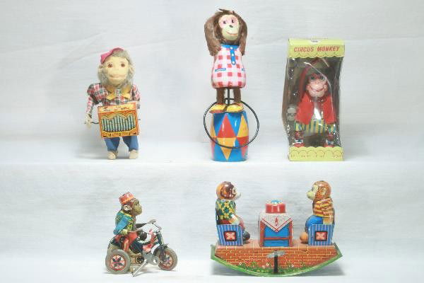 5 Piece Tin Monkey Toy Lot: Plaything Hula Hoop Monkey, 9 1/2" Tall, complete, mechanism slipping, minor staining, worn original box. German Monkey with organ, functional with plink-plank-plunk sound, some wear to tail. Factory