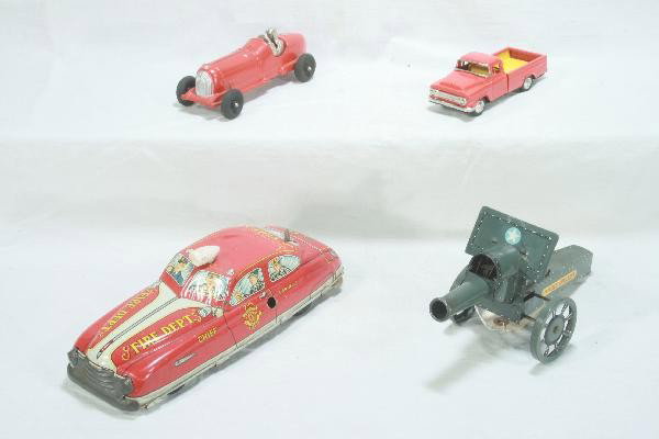 4 Pc. Toy Lot: Marx Fire Chief Car, mechanism functional, bat op light not working. 11 1/2" Long. 10" Marx Field Artillery Unit, mechanism functional, 6" Friction Ford Pick-up, original unmarked box. Like New 7" Hub