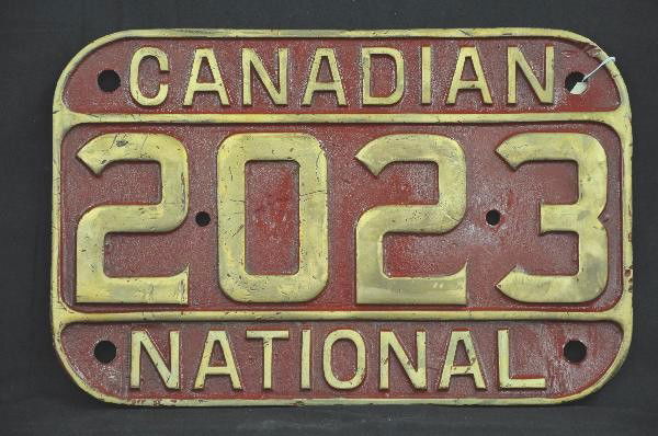 Brass Canadian National Locomotive Plate: 16 X 10 1/2", #2023, painted brass(heavy), shows wear. For Bigger and Better photos or information about consigning in our future events go to our website