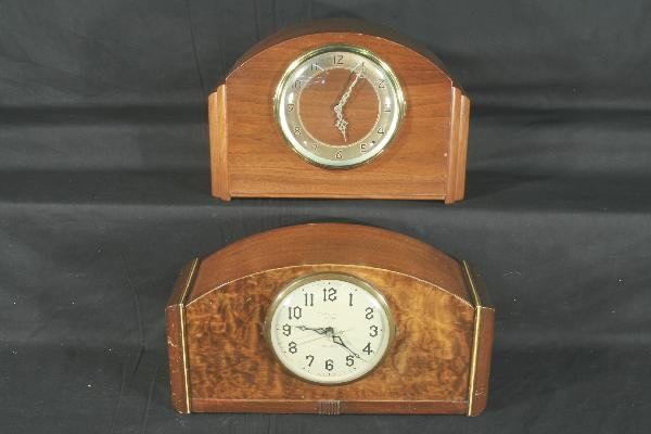 2 Art Deco Wood Case Clocks: 1944 New Haven "Orleans" model 15 X 5 X 9", Westminster chimes, burl walnut style front, cord frayed. 1948 Plymouth strike/chime with walnut face, 13 X 5 1/2 X 9", both show light wear. Clocks, Radios