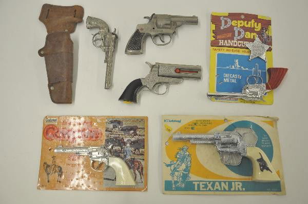 7 Pc. Cap Gun Lot: Hubley Texan Jr sealed on worn card, Gabriel Cowpoke sealed on card. Lone Star Deputy Dan with bag, partially banded to nice card. Cast Hubley Trooper, not functional. Hubley Dagger Derringer. Hubley